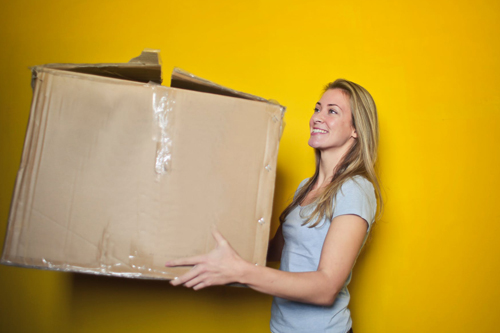 woman holding cardboard box